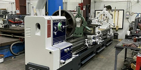 Machinery cleaning—large industrial lathe and equipment in a workshop prepared for detailed cleaning.