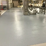 Industrial facility with smooth gray electrostatic dissipating flooring, designed to reduce static buildup and provide a durable, easy-to-clean surface.
