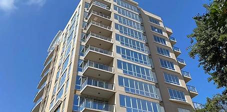 High-rise painting—tall residential building with clean painted exterior and multiple balconies.