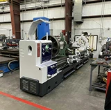 Industrial machine in a workshop after detailed cleaning, surrounded by other equipment and workbenches.